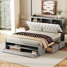 a bed with drawers underneath it in a room