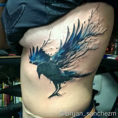 a woman's stomach with a bird tattoo on it