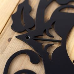 a wooden board with black metal designs on it