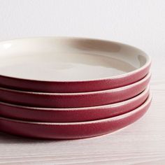 four red and white plates stacked on top of each other