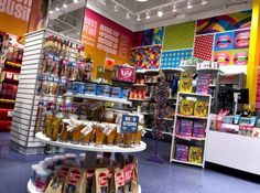 a store filled with lots of different types of items and drinks on display in front of the counter