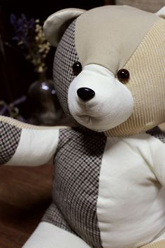 a teddy bear sitting on top of a wooden table