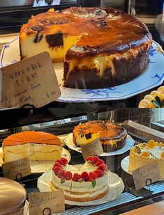 several different types of cakes on display in a case