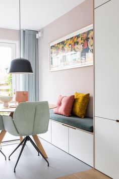 a dining room with a table and chairs next to a window