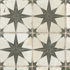 an old tile floor with black and white stars on it