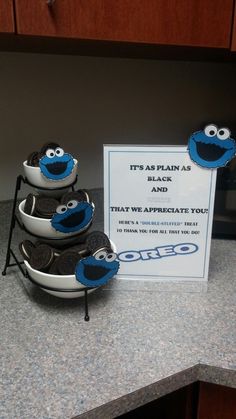 some cookies are sitting in bowls on the kitchen counter next to a sign that says it's as plain as black and sesame