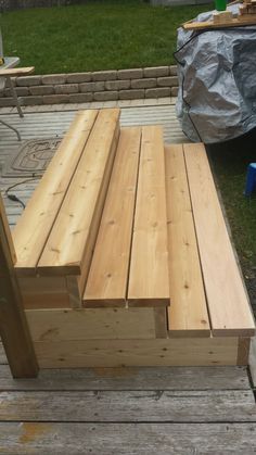 a wooden bench sitting on top of a wooden deck