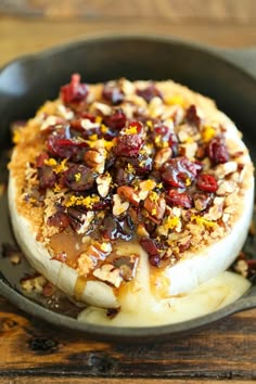 a skillet filled with food on top of a wooden table