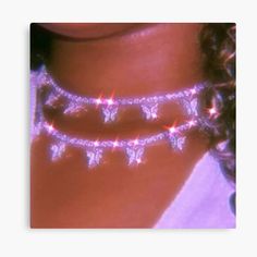 a close up of a woman's neck wearing a necklace with stars on it