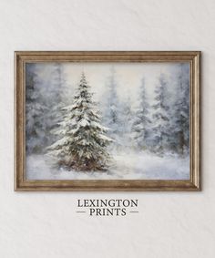 a painting hanging on the wall above a white wall with a brown frame and an image of a snow covered pine tree