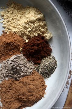 there are many different types of spices in the bowl on the table, all together