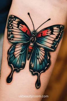 a colorful butterfly tattoo on the arm