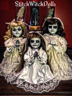 three dolls dressed up as brides sitting next to each other