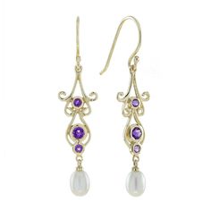 These pair of vintage-inspired amethyst and pearl earrings presents dazzling amethysts shimmer within ornate gold settings, evoking a sense of luxury and refinement. Delicate white freshwater pearls cascade gracefully below, adding a touch of sophistication and whimsical movement. Perfect for a grand entrance at a formal event or a statement piece for any special occasion, these earrings will elevate your look and turn heads wherever you go. CHARACTERISTICS Status: Made to order Origin: Thailand Vintage Inspired Earrings, Pearl Vintage, Earring Box, Amethyst Color, Gilded Age, Ruby Earrings, White Freshwater Pearl, Grand Entrance, Yellow Gold Earring