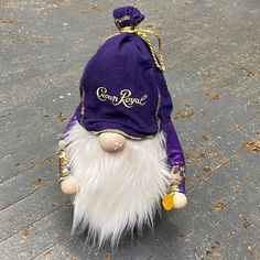 a purple and white gnome toy sitting on the ground