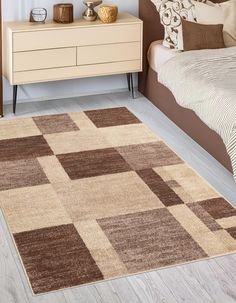 a brown and beige rug in a bedroom