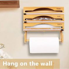 a wooden shelf with two rolls of toilet paper hanging on the wall above it is an image of a roll of toilet paper