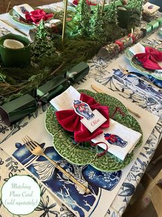 a table set for christmas dinner with place settings