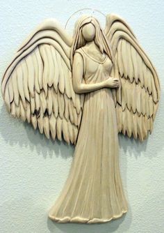 an angel statue is hanging on the wall