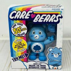 a blue bear toy in a box on a table