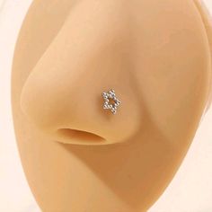 a close up view of a fake nose with an earring