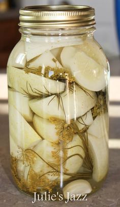 a jar filled with sliced up bananas and herbs