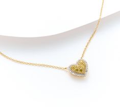 Glistening with prong-set white and colored diamonds, this exquisite necklace is perfect for adding a touch of elegance to any outfit. From Affinity® Diamonds. Heart-shaped Yellow Gold Diamond Necklace For Anniversary, Valentine's Day Yellow Gold Open Heart Diamond Necklace, Heart-shaped Yellow Gold Necklace With Diamond Accents, Yellow Heart-shaped Necklaces For Anniversary, Valentine's Day Heart Pendant Yellow Gold Diamond Necklace, Colorful Heart, Prong Setting, Colored Diamonds, Diamonds