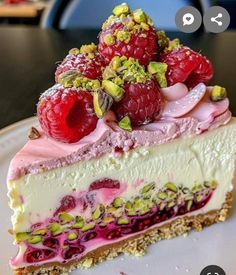 a piece of cheesecake with raspberries and pistachios on top