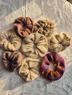 six different types of scrunffles on a white tablecloth, with one in the middle