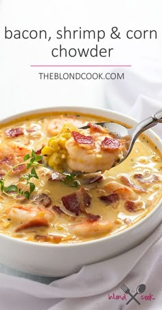 a spoon full of soup with shrimp, corn and bacon in it on a white plate