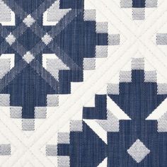 a blue and white quilt with an abstract design