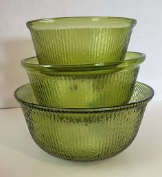 three green glass bowls stacked on top of each other