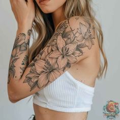 a woman with tattoos on her arm and shoulder