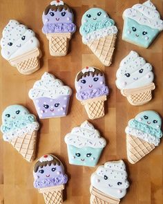 there are many decorated ice cream cones on the table with one cookie in the shape of an ice cream cone