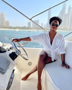 a woman sitting on the back of a boat