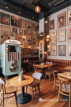 the interior of a restaurant with wooden tables and chairs, pictures on the wall behind them