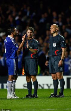 two soccer players talking to each other on the field