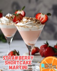 strawberry shortcake martini with whipped cream and fresh strawberries on the rim, served in coupe glasses