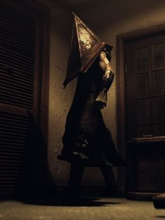 a woman in a dark room with an umbrella on her head