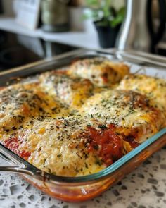 a casserole dish with cheese and tomatoes