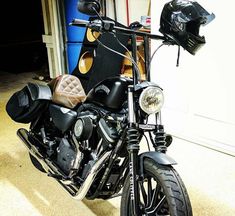 a black motorcycle parked in front of a garage