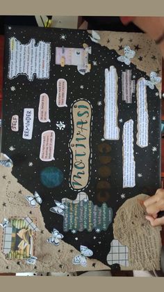 a person holding up a piece of paper with writing on it and space in the background