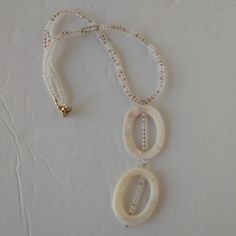 This Pretty Piece Of Jewelry Is Designed With Oval Shaped, Off White ,Dyed Shells With Flecks Of Brown And Grey, And Seed Beads In Shades Of White, Gold, And Copper. Necklace Features Gold Plated Double Lobster Claw Closure. Pretty Necklace Measures 15.75 Inches In Length Around The Neck. Shell Pendant Measures 1.5 Inches Across With A 3.5 Inch Drop. Each Shell Measures 1.5x1.75 Inches. *All Items From Pet Friendly/Smoke Free Environment. Gray Earrings, Color Accents, Brown Necklace, Baroque Pearl Earrings, Pretty Necklaces, Beaded Skull, Skull Earrings, Handcrafted Necklace, Gold Copper