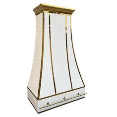 a white and gold colored stove hood on a white background with the light reflecting off it's side