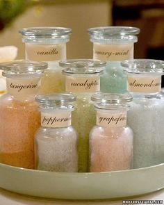 there are many different colored salts in glass jars