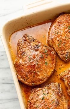 four pieces of cooked meat in a casserole dish