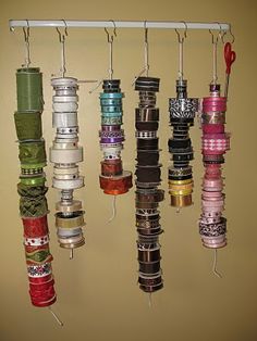 a rack with many different types of ribbons hanging from it's hooks and strings