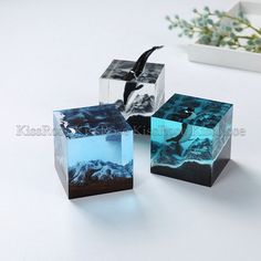 three cubes that have been designed to look like they are floating in the water