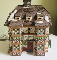 a small house made out of clay sitting on top of a table