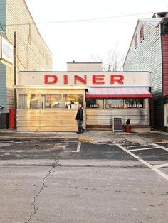 a man walking in front of a diner